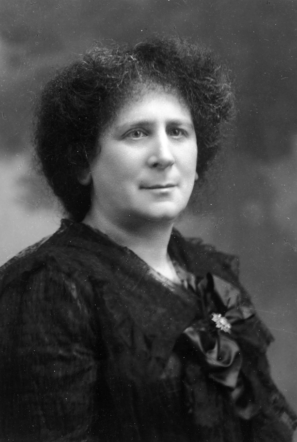 Woman in black jacket with bow