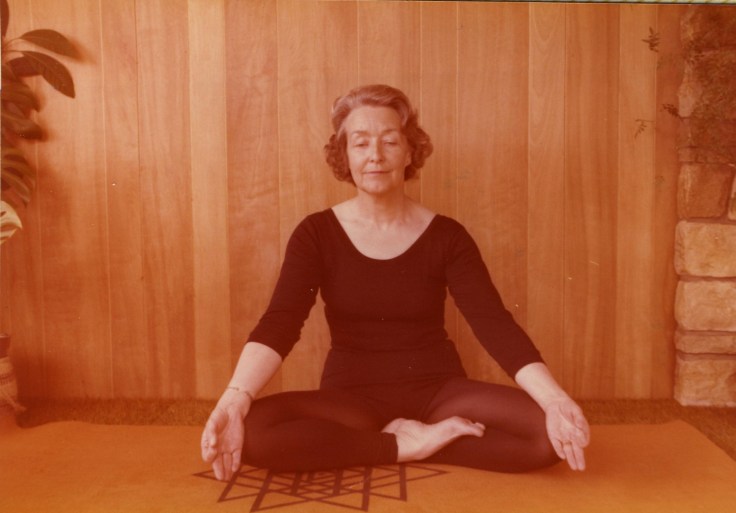 Woman in black leotard in yoga pose