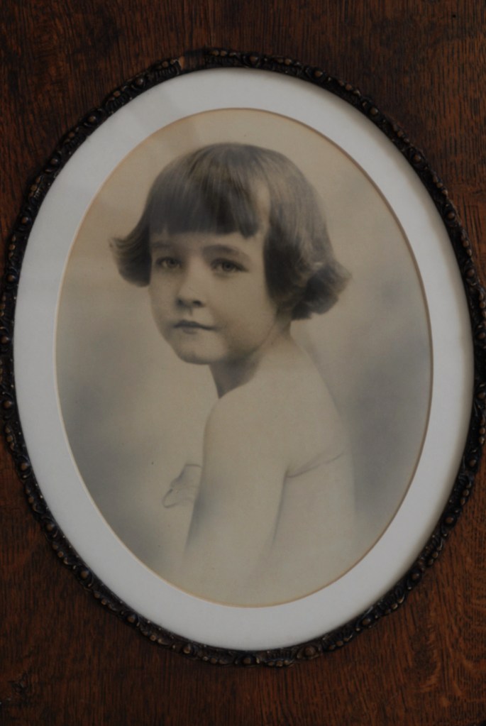 Photograph of child in oval frame
